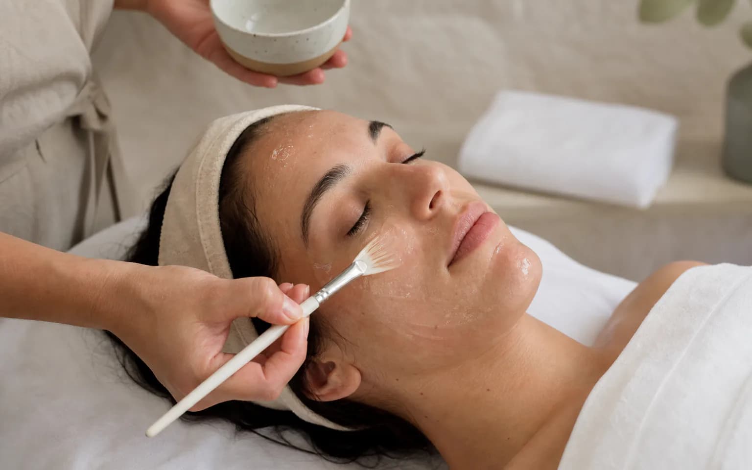 A customer receiving a facial treatment